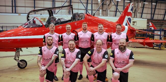Red Arrows football team in front of Red Arrow