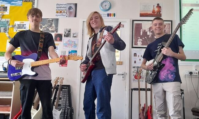 Students holding guitars