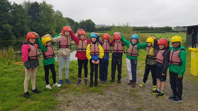 Airplay children standing with helmets on for water sports