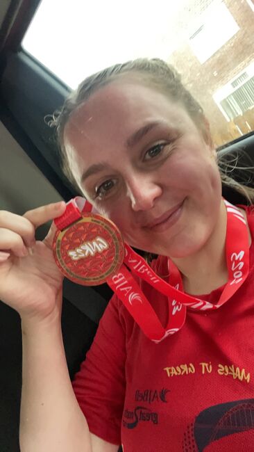 Katy holding up her medal