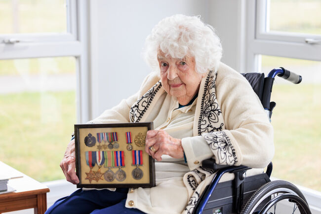 Margaret Garrett holding medals