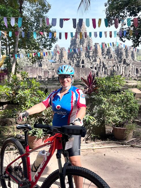 Trish with bike in front of temple
