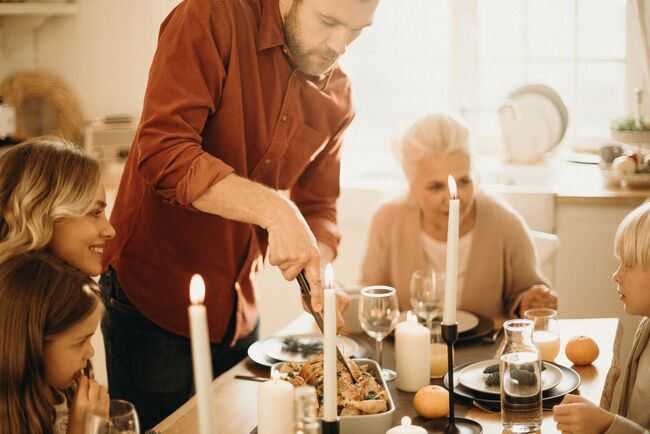 Man serving Christmas dinner at family table