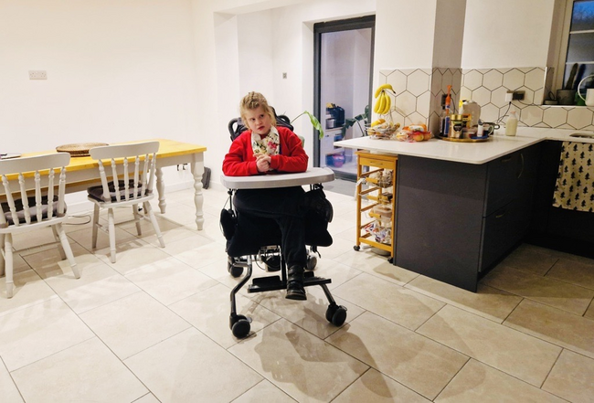Lucia in wheelchair in spacious new open plan kitchen