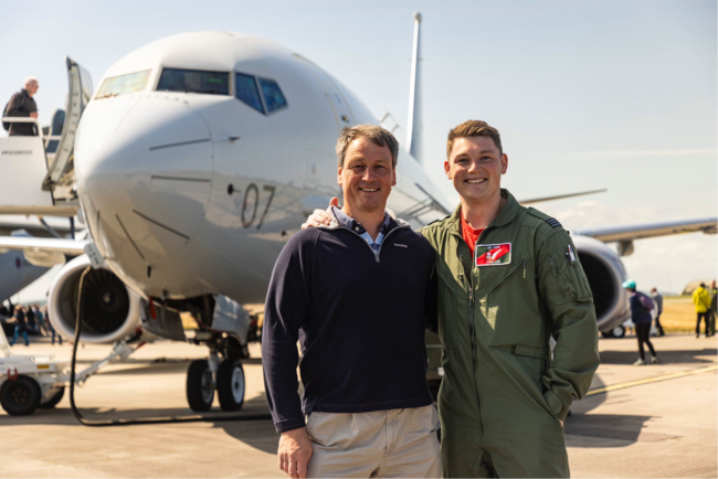 Nigel and Tom standing in front of P-8 Poseidon at Lossiemouth