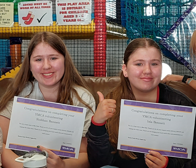 Isla and Siobhan Bennett smiling holding certificates 