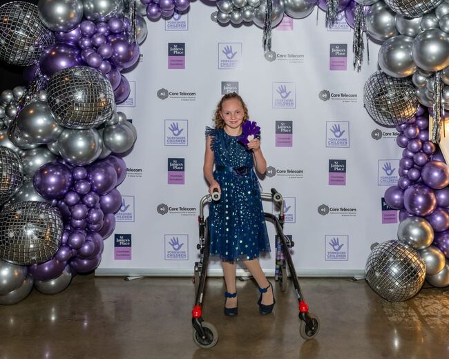 Emily posing with walker after winning her award