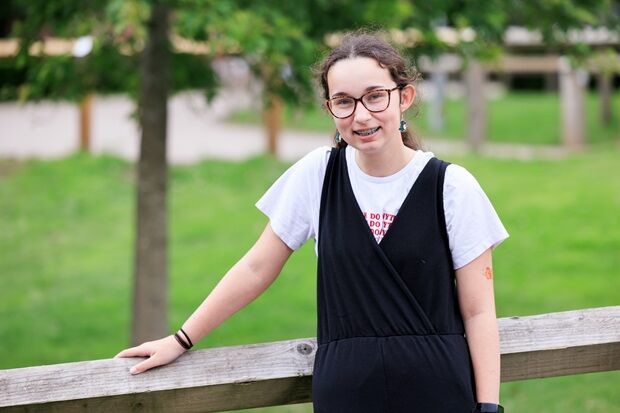 Jessica smiling leaning on fence