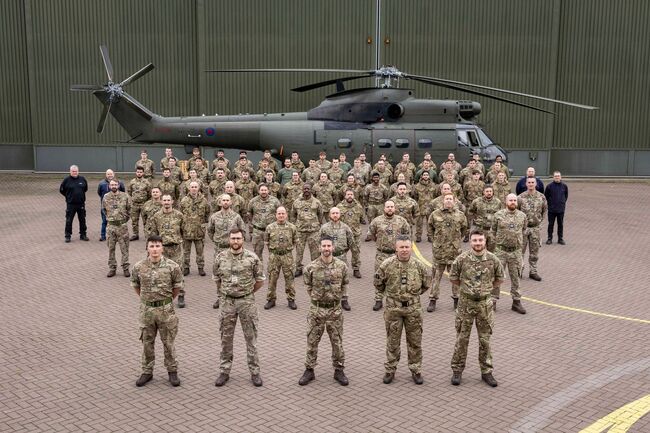 RAF Squadron in front of helicopter