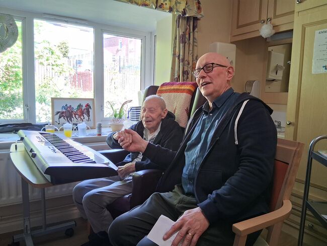 Doug Felgate with Paul learning piano