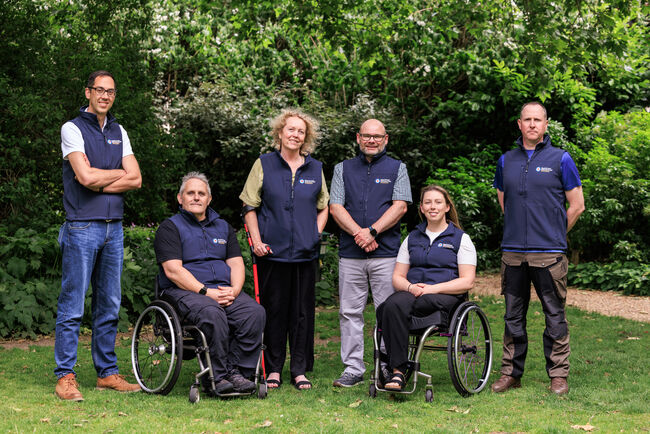 6 of the ambassadors in their Fund gilets posing in the garden