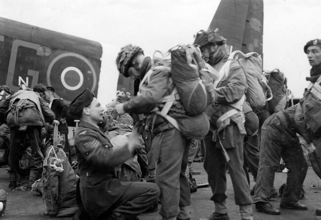 Members of the 5th Parachute Brigade Group have their equipment checked for the last time before boarding waiting aircraft and gliders at Keevil, Wiltshire, for the flight to Normandy and the start of Operastion TONGA on 5 June 1944.