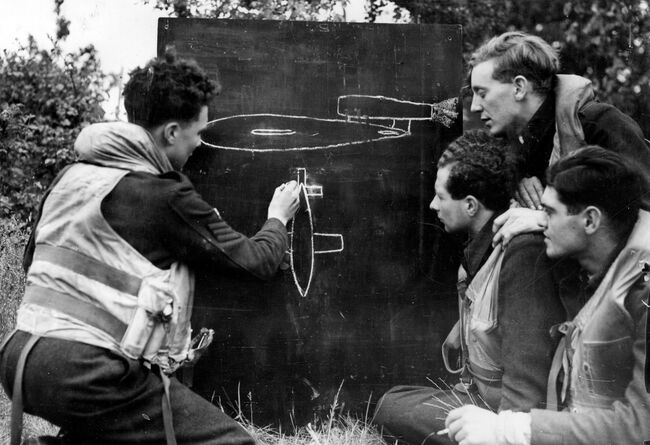 Flight Sergeant Morris Rose of 3 Squadron points out the essential characteristics of the V-1 flying bomb to other Tempest pilots at Newchurch, 23 June 1944. The Scottish pilot downed his first 'doodlebug' on 16 June, and by the end of July had claimed a total of 11 destroyed.