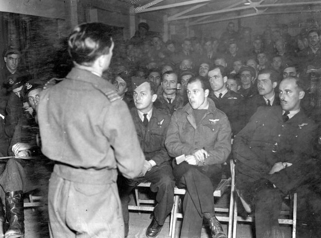 A final briefing erly in the morning of 6 June 1944 for Douglas Boston crews of 137 Wing at Hartford Bridge, Hampshire, before they depart on smoke-laying sorties off the French coast to shield the Allied invasion fleet from enemy shore defences.