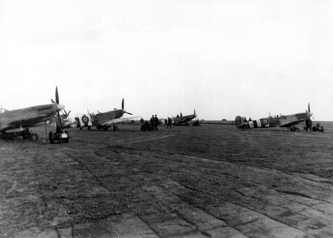 Supermarine Spitfires IXs of 144 (Canadian) Wing, the first RAF Wing to fly into France post-D-Day, at readiness on the advanced landing ground at B3/Ste-Croix-sur-Mer, Normandy, 10 June 1944. The second aircraft from the left is coded "2I-N" of 443 Squadron RCAF.