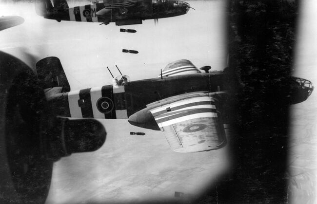 North American Mitchell IIs of 226 Squadron based at Hartford Bridge, Hampshire, dropping 500lb MC bombs over the Foret de Gambosq, south of Caen, Normandy, in the evening of 12 June 1944. This operation was the biggest daylight raid mounted by 2 Group since D-Day, in which 90 aircraft bombed the 21st Panzer Division which was dispersed in the forest.
