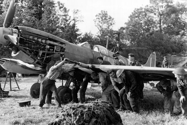 Members of 410 Repair and Salvage Unit in Normandy replace the wing of a Supermarine Spitfire IX of 403 Squadron RCAF at B2/Bazenville on 19 June 1944.