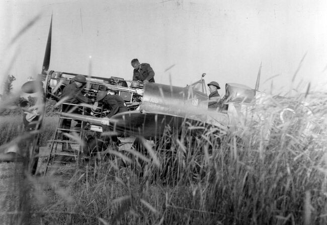 Repairs to an RAF Spitfire on a landing strip in Normandy, 20 June 1944.