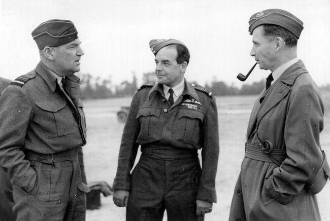 Air Marshal Sir Arthur Coningham, Air Officer Commanding-in-Chief 2nd Tactical Air Force (left), and Air Vice Marshal Harry Broadhurst, Air Officer Commanding 83 Group (centre), confer with Air Chief Marshal Sir Arthur Tedder, Deputy Supreme Commander Allied Expeditionary Forces, at B2/Bazenville during the latter's visit on 29 June 1944.