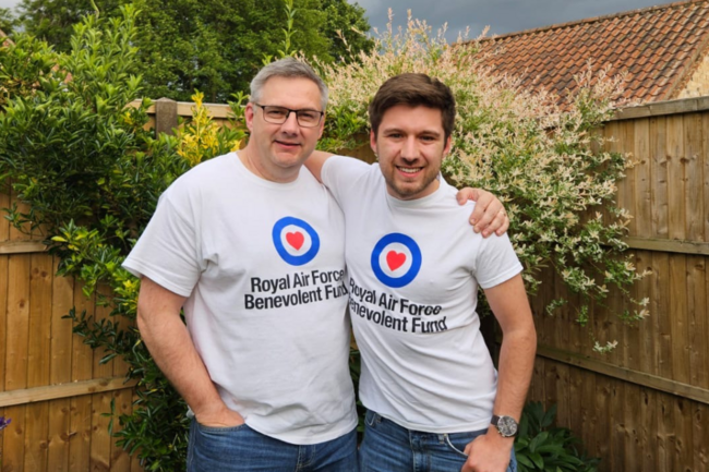 Liam and dad arms around each other in garden wearing fund logo tshirts