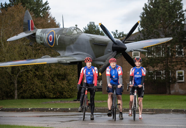 Cyclists in front of plane