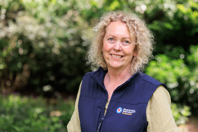 Ann smiling in Fund gillet outdoors in greenery