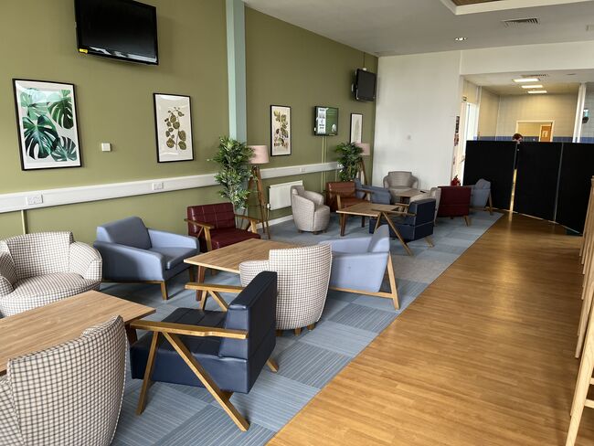 Renovated hub with chairs tables picture frames