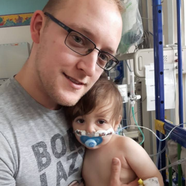 An image of John Cross with his baby boy in hospital