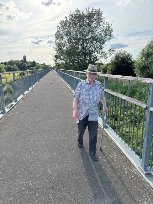 Joe walking on a bridge