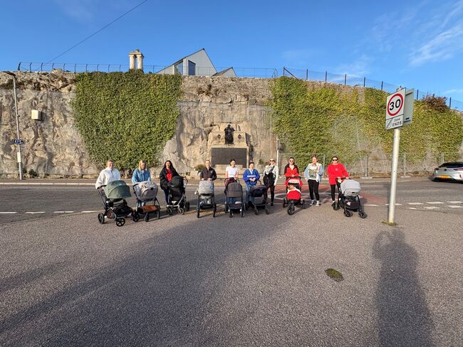 Mums with strollers in front of cliff