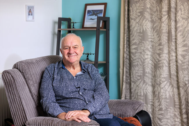 RAF veteran sitting on chair in living room
