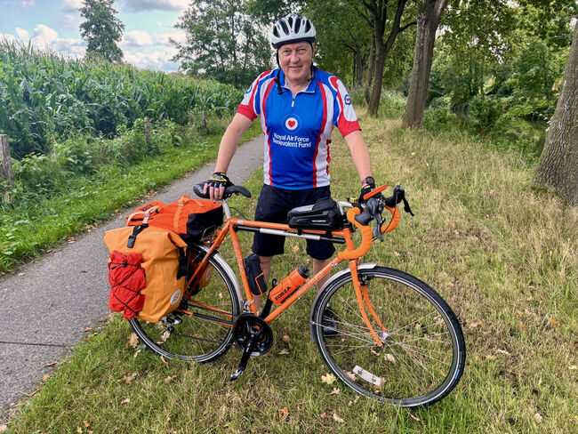 Tony standing with bike in Fund vest in Arnhem