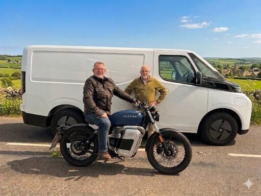 Tony on motorbike and Trevor standing next to him in countryside
