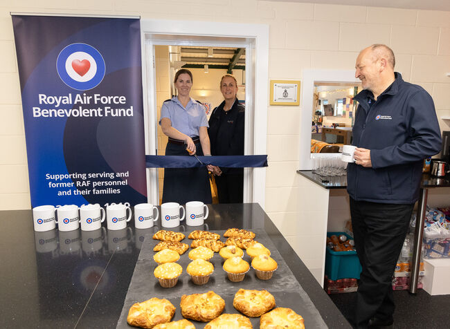 Stn Cmdr, Serco rep and Fund rep in new kitchen cutting ribbon