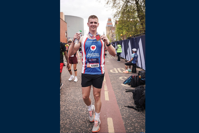 Caylum in Fund vest holding medal up 