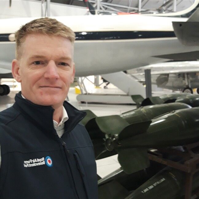 RAF Benevolent Fund, caseworker Matt in front of an aircraft.