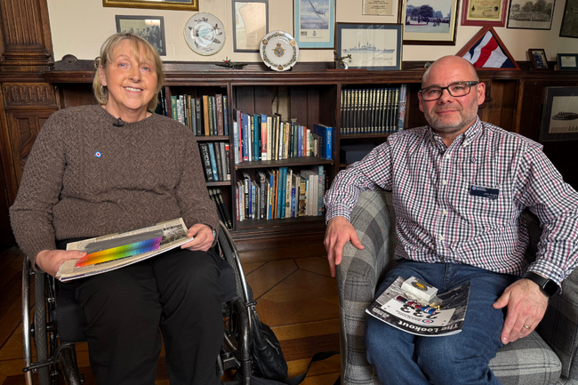 Joanna and John sat side by side smiling