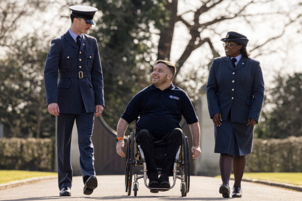 An image of two serving personnel and a veteran in conversation at Runnymead.