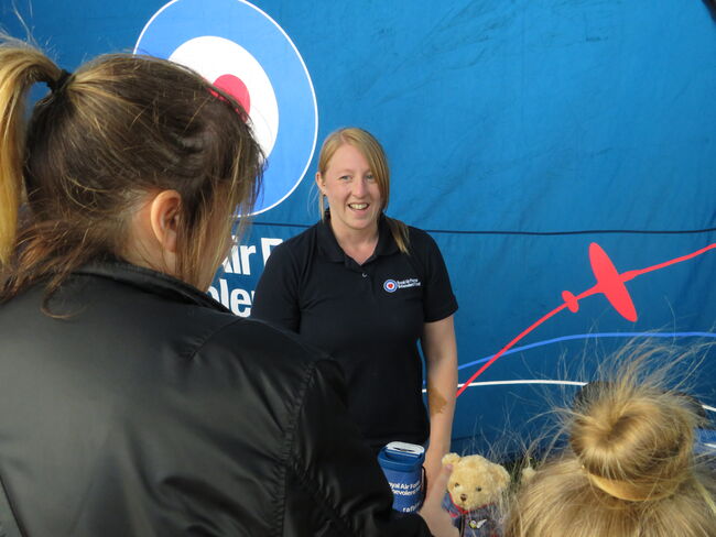 A worker from the Royal Air Force Benevolent at their Ayr Show marquee, speaking with a member of the RAF Family.