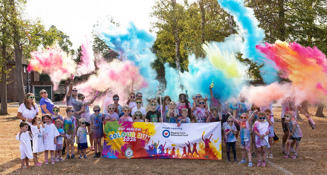 RAF Henlow children pose in streams of colour powder and Fund tshirts